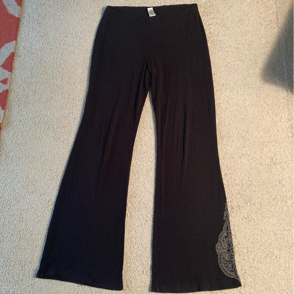 Prana black yoga pants with tattoo detailing on one leg